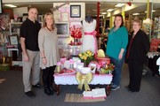 three women and one man pictured together with a valentine's day display